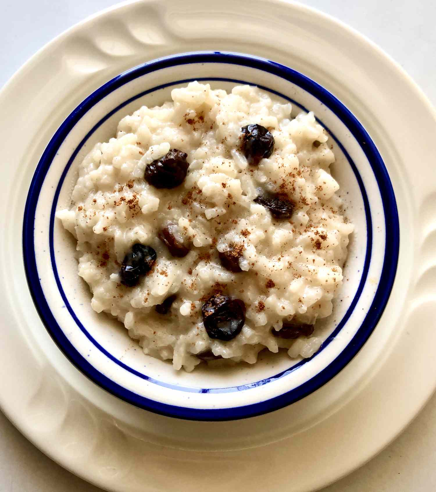 Rice pudding with raisins, almonds and coconut syrup